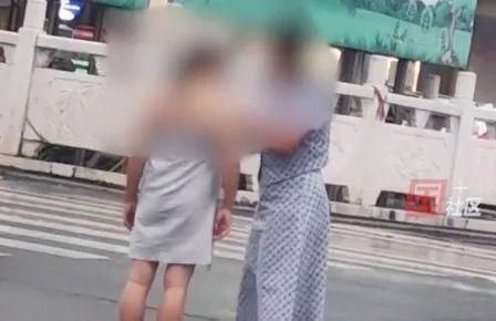 洛阳女子赤裸全身站在街头,路人围观拍照,好心人为她裹上围巾